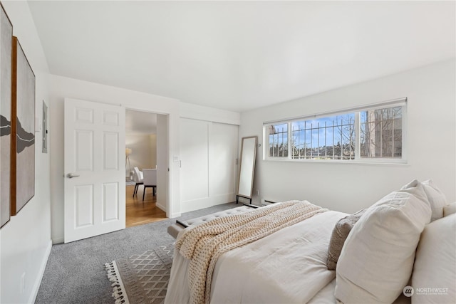 bedroom featuring light carpet and a closet