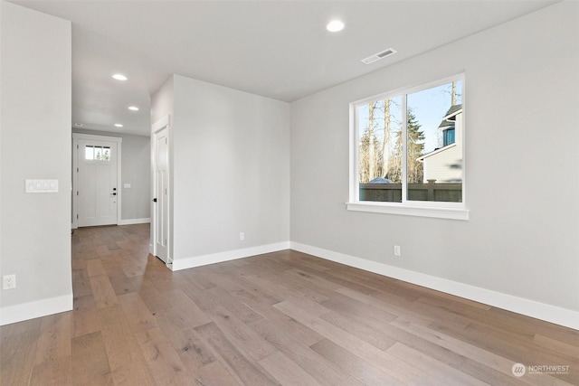 spare room featuring light hardwood / wood-style flooring