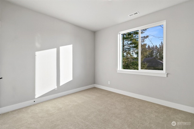 empty room featuring light colored carpet