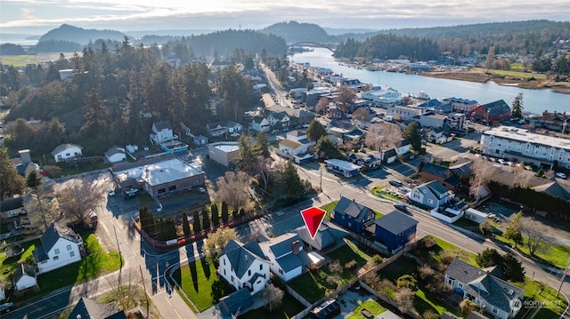 birds eye view of property with a water and mountain view