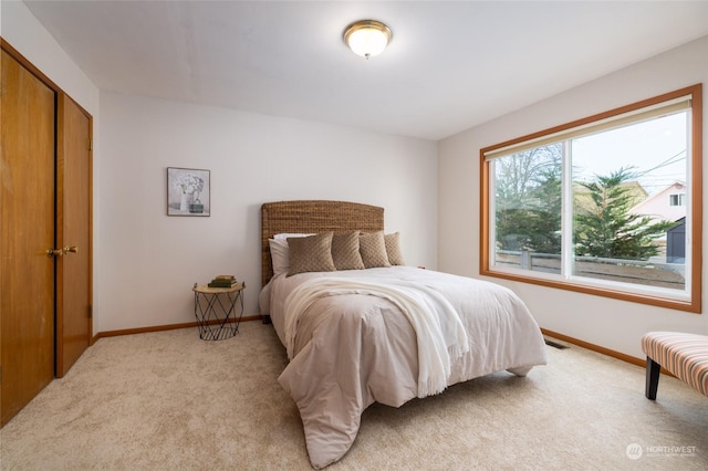 carpeted bedroom with a closet