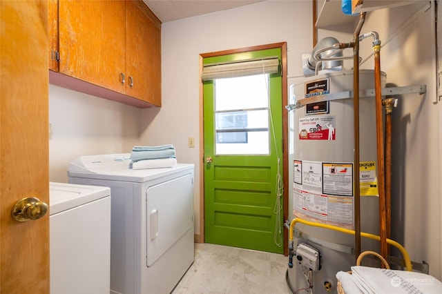 laundry area with cabinets, independent washer and dryer, and gas water heater