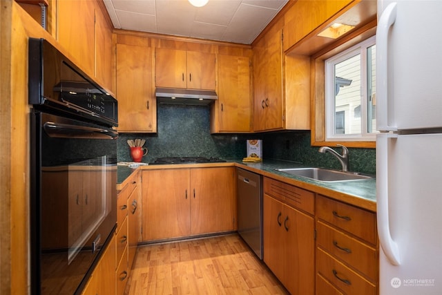 kitchen featuring oven, sink, stainless steel dishwasher, tasteful backsplash, and white fridge