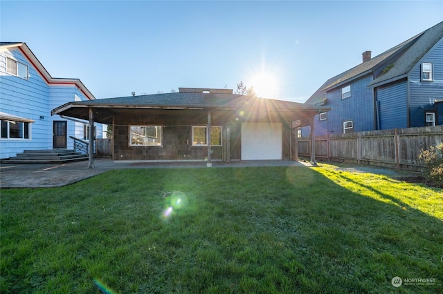 back of house with a lawn and a patio