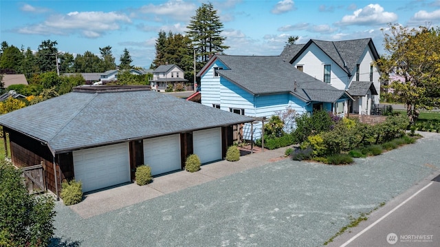 307 Center St, La Conner, WA 98257 - view of front facade with a garage and a shingled roof