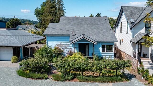 307 Center St, La Conner, WA 98257 - view of front facade featuring a garage, a shingled roof, and concrete driveway