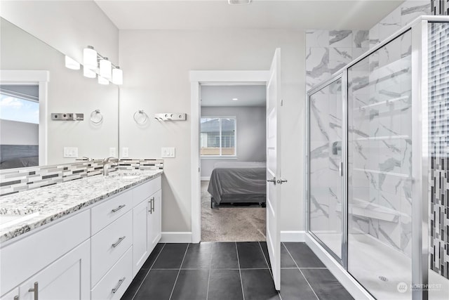 bathroom featuring tile patterned flooring, vanity, tasteful backsplash, and walk in shower