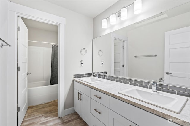 bathroom featuring vanity, hardwood / wood-style flooring, and shower / bath combo