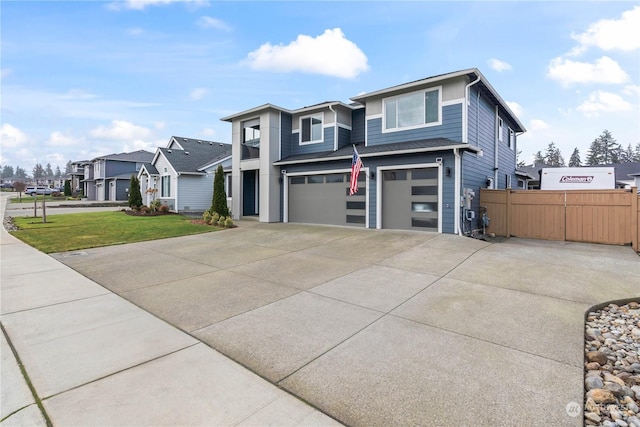 view of front of home featuring a garage and a front lawn