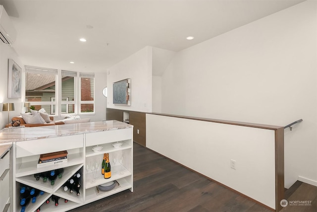 interior space with an AC wall unit and dark hardwood / wood-style floors