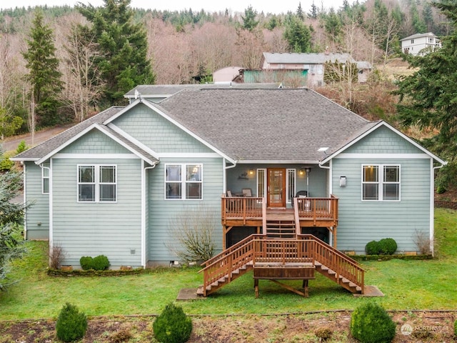 back of house with a wooden deck and a yard