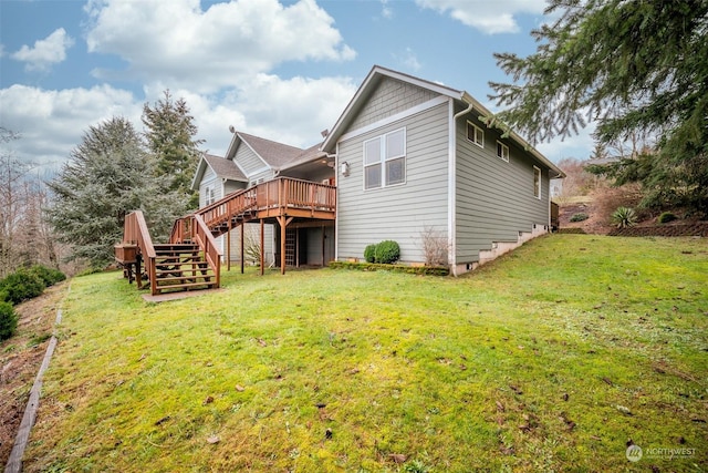 rear view of house with a deck and a lawn