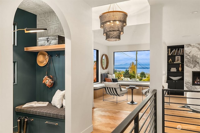 interior space with parquet flooring, an inviting chandelier, and built in features