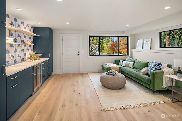 living room featuring light wood-type flooring and sink