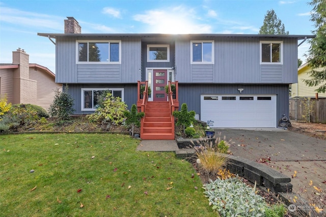 split foyer home featuring a garage and a front yard