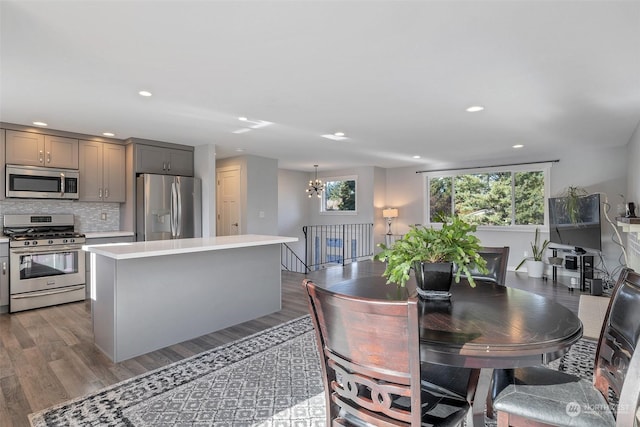 dining room with light hardwood / wood-style floors and a notable chandelier