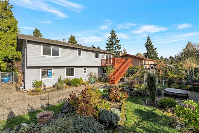 rear view of property featuring a deck