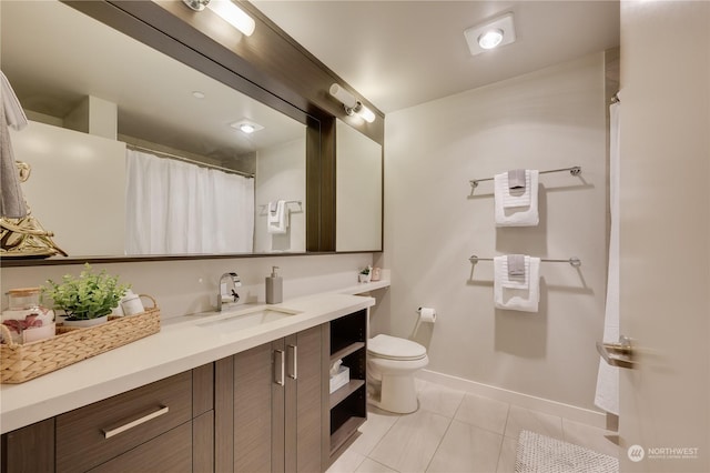 bathroom with tile patterned floors, vanity, and toilet