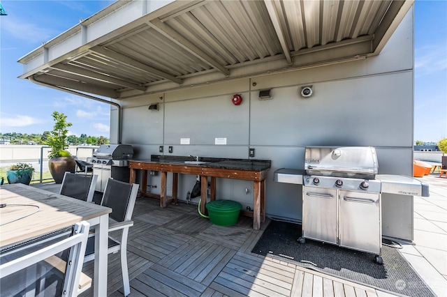 wooden terrace with a grill and sink