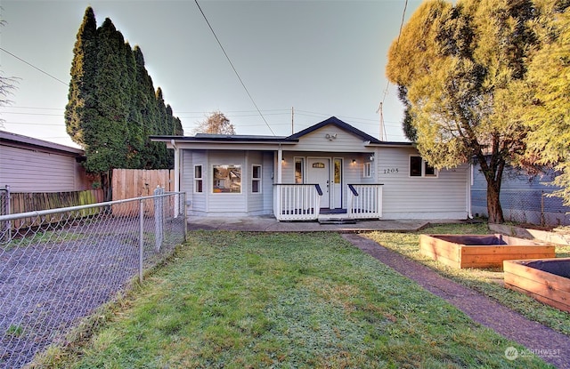 ranch-style home with a porch and a front lawn