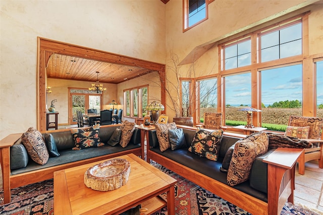 living room with a towering ceiling, an inviting chandelier, and wood ceiling