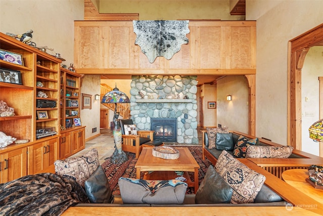 living room featuring a stone fireplace