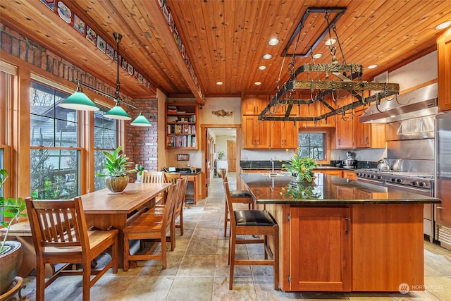 kitchen with wooden ceiling, dark stone countertops, hanging light fixtures, a kitchen island, and beam ceiling