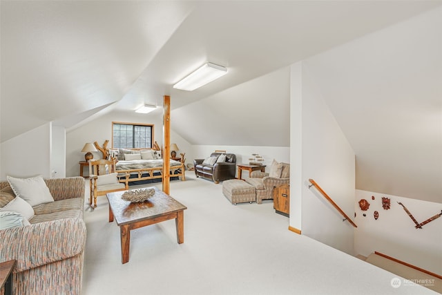 carpeted living room featuring lofted ceiling