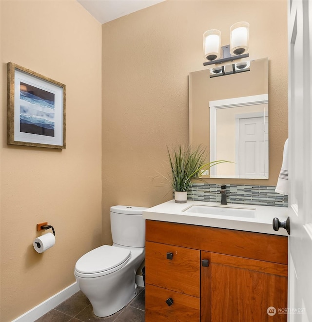 bathroom with tile patterned floors, vanity, toilet, and backsplash