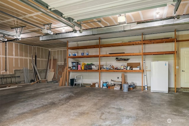 garage with white fridge and a garage door opener