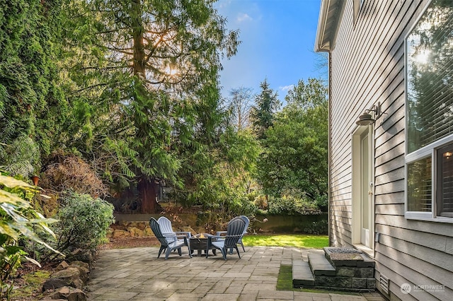 view of patio / terrace featuring an outdoor fire pit