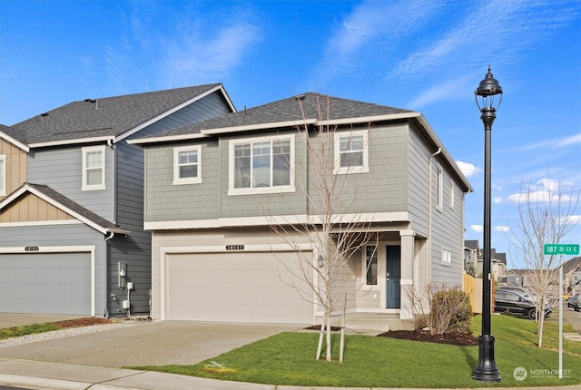 view of front facade with a garage and a front lawn