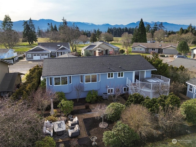 rear view of property with a deck with mountain view