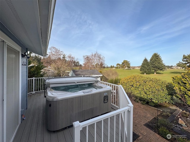 wooden terrace with a hot tub