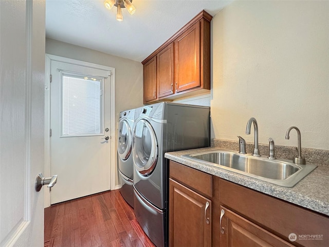 clothes washing area featuring cabinets, separate washer and dryer, sink, and dark wood-type flooring