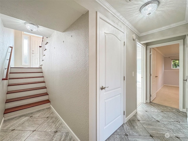 stairs with crown molding and a textured ceiling