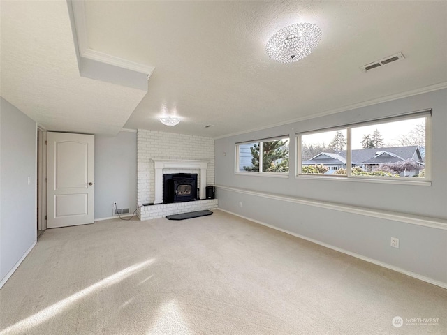 unfurnished living room with light carpet, a brick fireplace, crown molding, and a textured ceiling