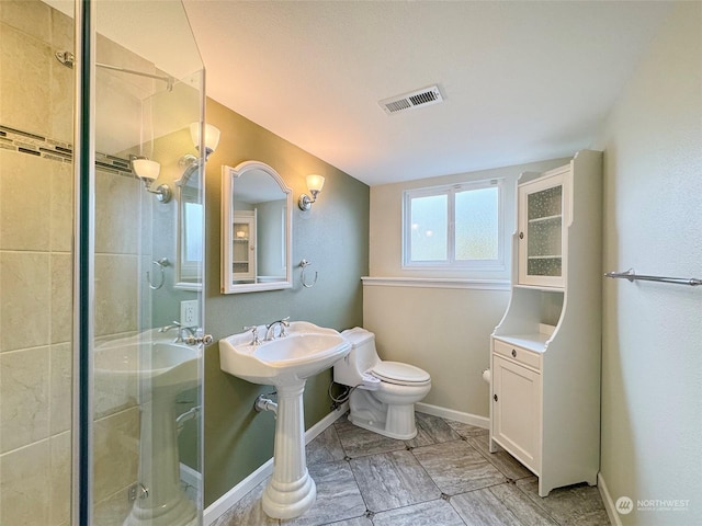 bathroom with an enclosed shower and toilet