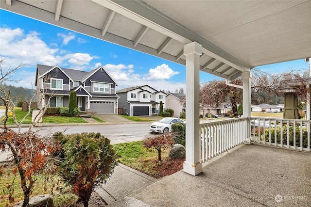 view of patio / terrace featuring covered porch and a garage