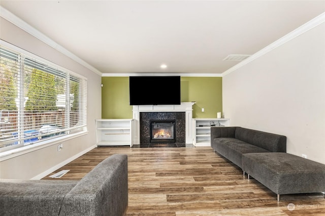 living room featuring a fireplace, hardwood / wood-style flooring, and ornamental molding