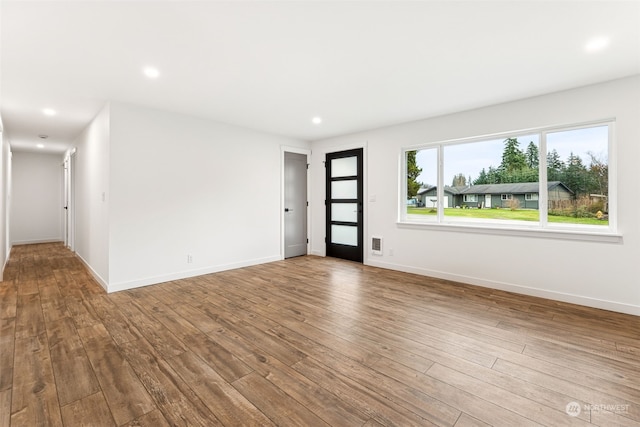 unfurnished room with hardwood / wood-style flooring