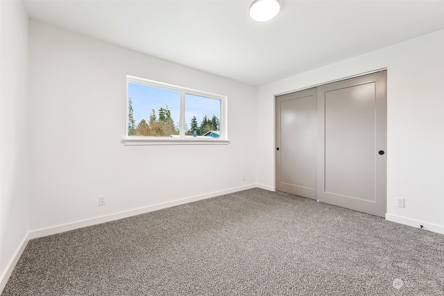 unfurnished bedroom with carpet and a closet