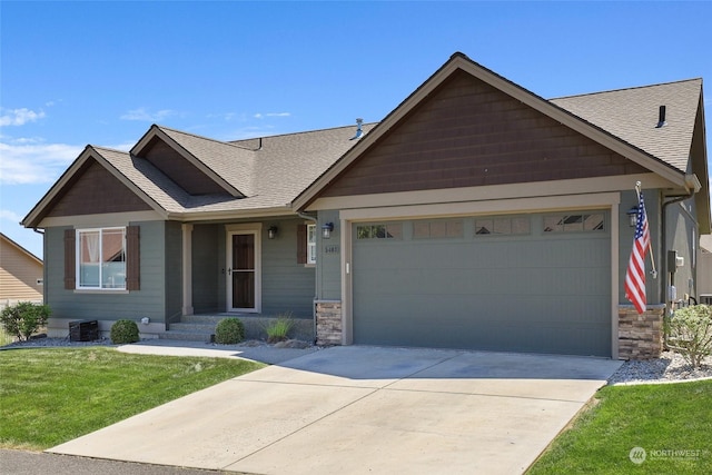 view of front of house with central air condition unit, a front yard, and a garage