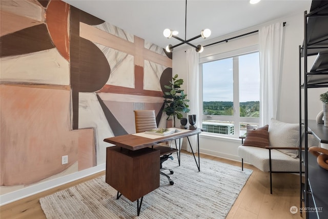 office with a notable chandelier and light wood-type flooring