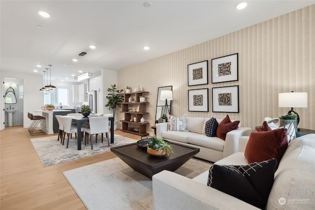 living room featuring light hardwood / wood-style floors and sink