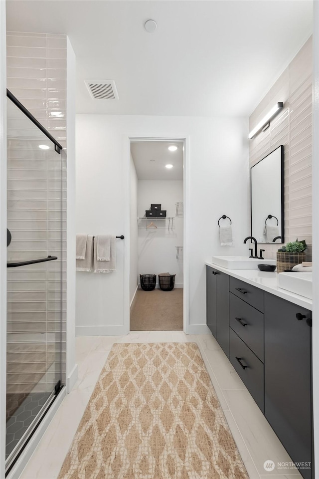 bathroom with vanity and a shower with shower door