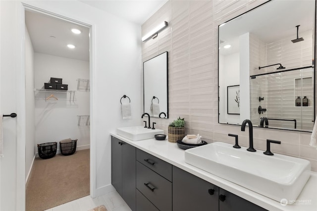 bathroom featuring vanity, walk in shower, and tasteful backsplash