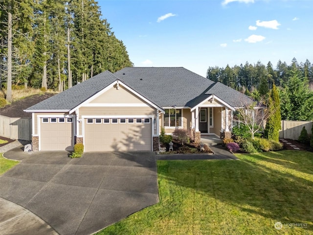 view of front of home featuring a front yard and a garage