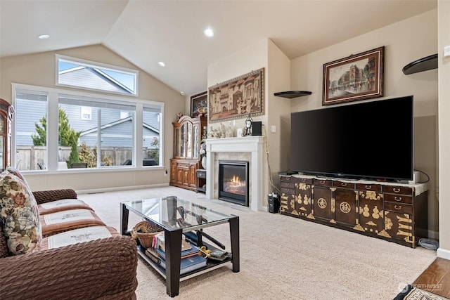 carpeted living room featuring lofted ceiling