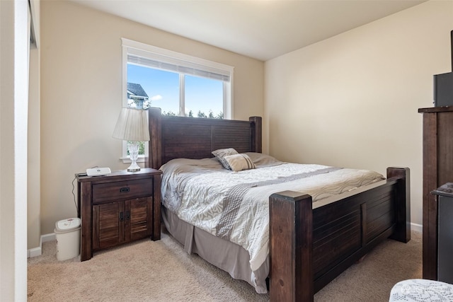 bedroom featuring light carpet